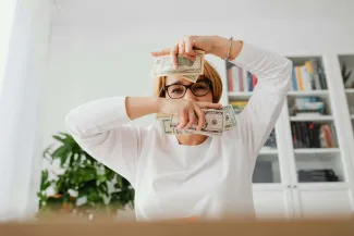 Woman holding dollar bills